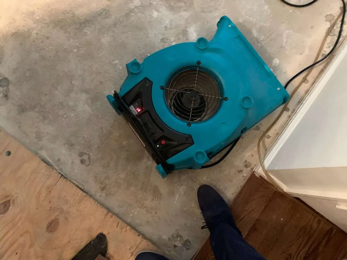 Air mover drying subfloor during Leak Detection & Repair in Tomah